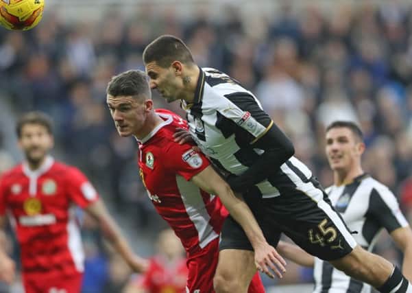 Newcastle Uniteds Aleksandar Mitrovic (right) jumps highest to win the ball ahead of a Blackburn Rovers player.