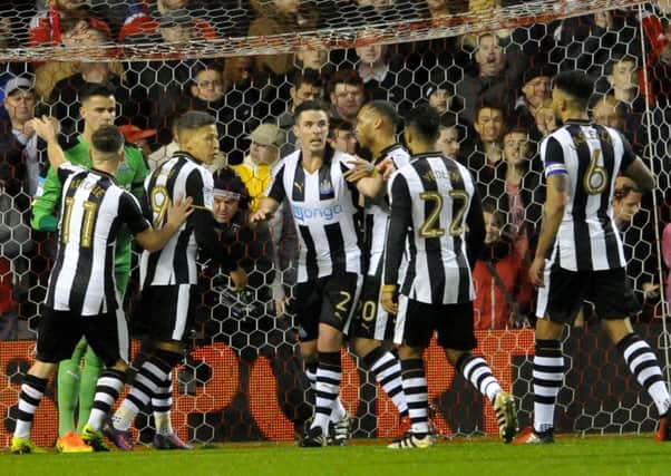 Karl Darlow gets congratulated on his two penalty saves for Newcastle at Forest. Picture by Frank Reid