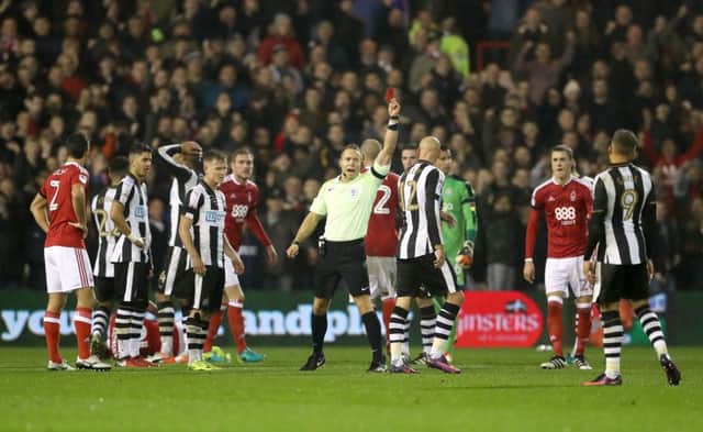 Newcastle United's Jonjo Shelvey receives a red card from referee Stephen Martin after a challenge on Nottingham Forest's Henri Lansbury during the Sky Bet Championship match at the City Ground, Nottingham. PRESS ASSOCIATION Photo. Picture date: Friday December 2, 2016. See PA story SOCCER Forest. Photo credit should read: David Davies/PA Wire. RESTRICTIONS: EDITORIAL USE ONLY No use with unauthorised audio, video, data, fixture lists, club/league logos or "live" services. Online in-match use limited to 75 images, no video emulation. No use in betting, games or single club/league/player publications.