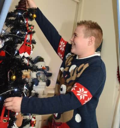 Dylan putting the finishing touches to his tree.