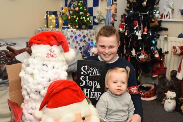Dylan Simpson with his sister Ava  in his bedroom which he turned into a Santa's Grotto.