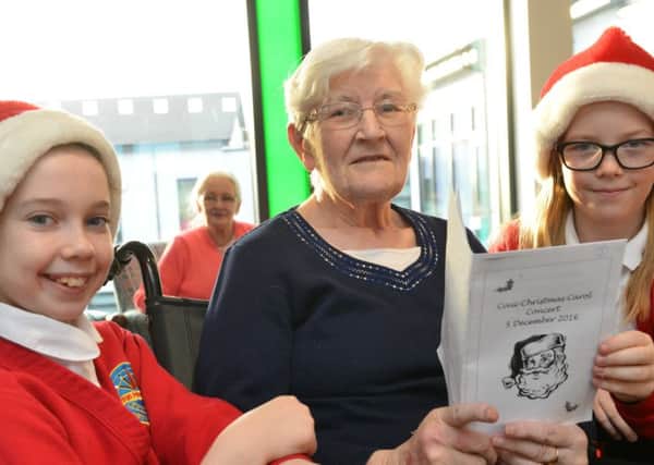 Harton Primary School pupils Christmas carol service at Haven Court Pupils from left Charlotte Harwood aged 10, resident Shirley Purvis and Lucie Finn aged 10