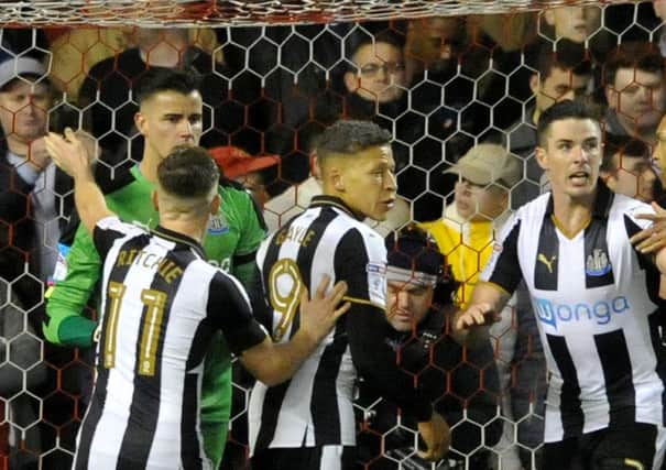 Karl Darlow is congratulated after a penalty save at Forest
