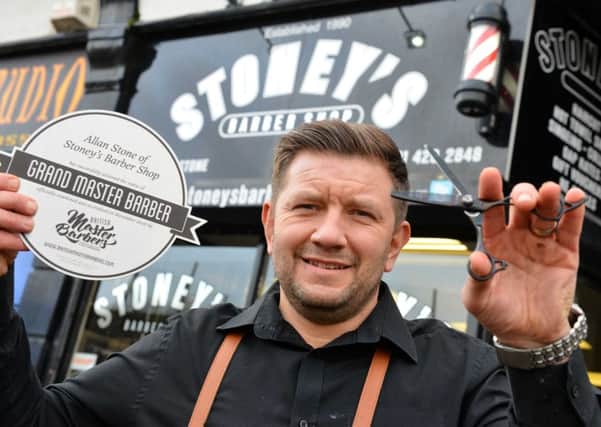 Grand Master Barber Allan Stone with his award.