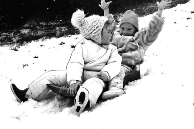 Katie Ford and Kia Forster sledging  in 1987.
