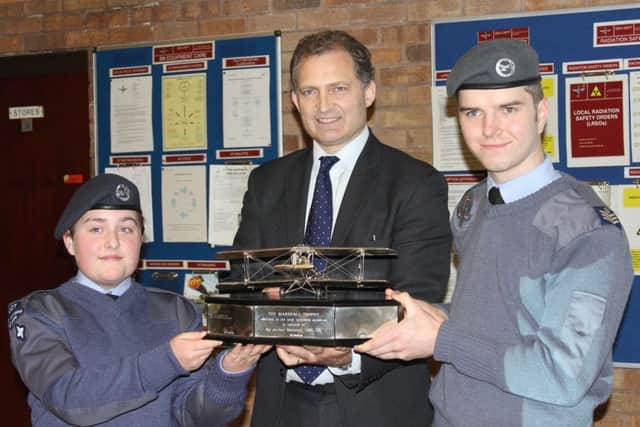 Cadets Nathan Benson and Skye Tilson receive the award from Robert Marshall, director of Marshalls of Cambridge Aerospace.