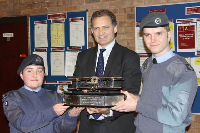 Cadets Nathan Benson and Skye Tilson receive the award from Robert Marshall, director of Marshalls of Cambridge Aerospace.