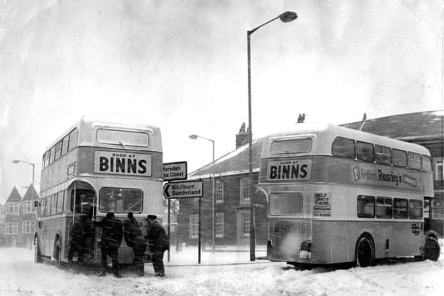 It's February 1970  and crews are pictured pushing one of their buses out of a drift on the Coast Road.