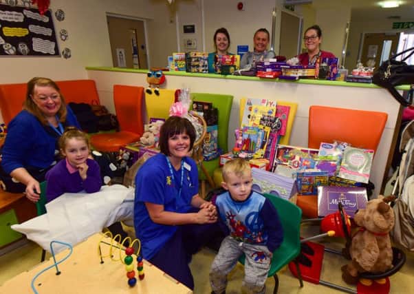 Viv Watts (left) of Hope 4 Kidz delivering toys to the childrens' A & E ward at South Tyneside Hospital. She's pictured with patients Aimee Gray (7) and Scott McLean (4) and staff Jane Grundy front at l-r standing Dr Faye McCorry, Mauren Brand and Danielle Murray.