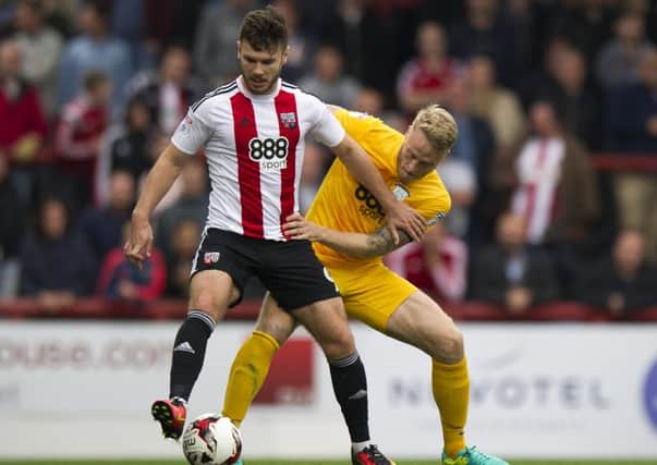 Brentford's Scott Hogan shields the ball.
