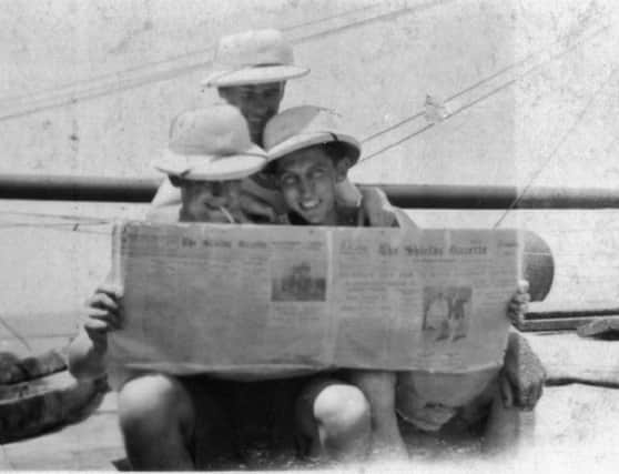 Three officers reading the Shields Gazette on board the vessel Nurtureton, while it was  moored in Bombay in 1934/35. This is the vessel Joe R Franklin (pictured in the centre of the photograph) was serving on just prior to the publication of the stowaway story. Ann would like to know the names of the other two officers.
