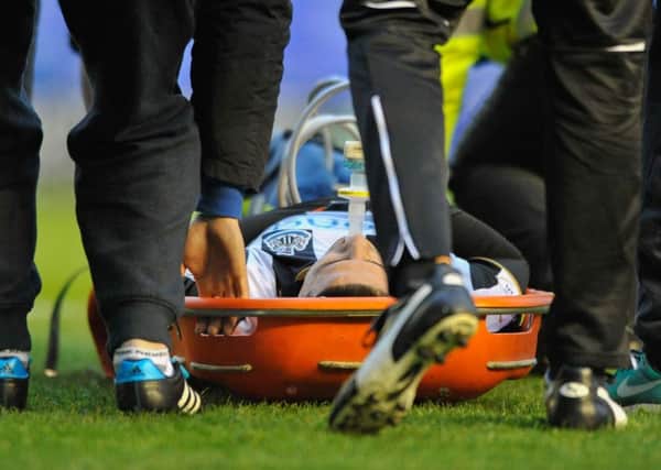 Aleksandar Mitrovic is stretchered off after sustaining a leg injury at Birmingham City on Saturday. Picture by Terry Rickeard.