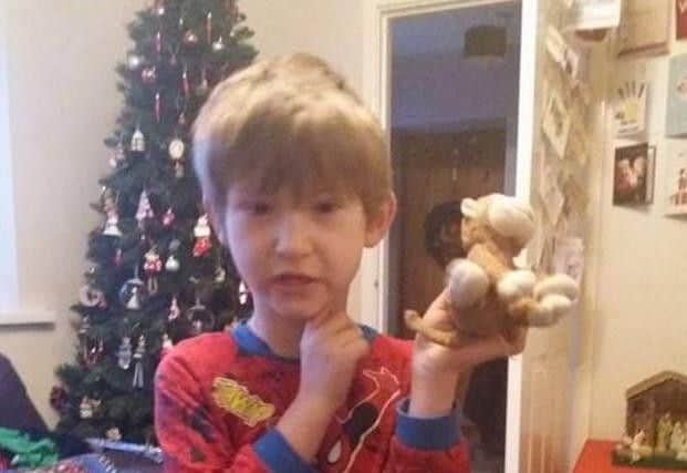 Five-year-old Thomas with Monkey back in his hands.