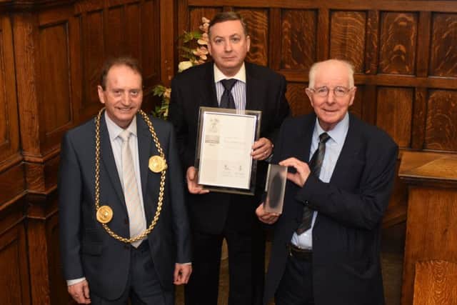 The Mayor of South Tyneside, Coun Alan Smith, with Coun Ed Malcolm, holding South Tyneside Councils Silver Employer Recognition (ERS) Award, and Coun Alan Kerr holding The Words Living North Award for Best Regeneration and Restoration project.