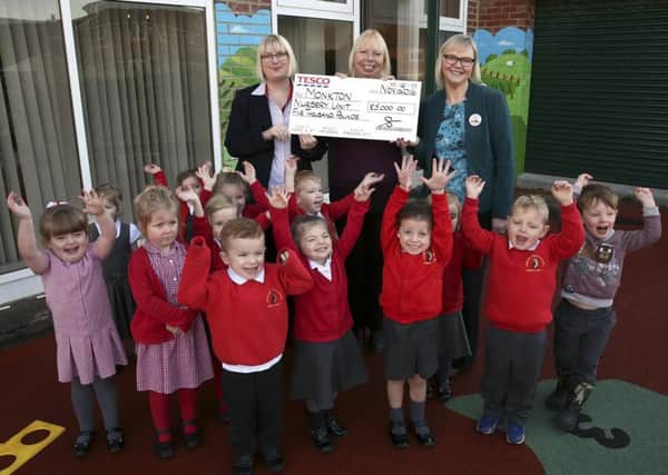 Children from Monkton Nursery School, South Shields, thank Tesco's for the Â£5000 dunation, with them left to right, Services Manager Helen Craig, Head Teacher Clare Askwith and Store Manager Helen Harber.
