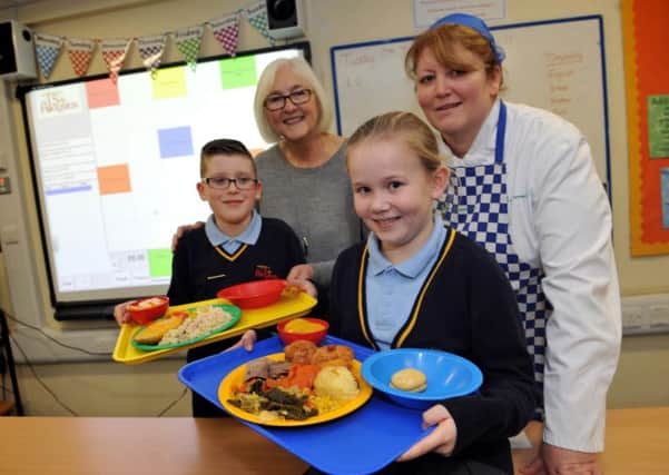 Coun Joan Atkinson joins St Aloysius Primary Federation pupils Ethan Holmes and Jessica Kane, with cook in charge Judith Todd.