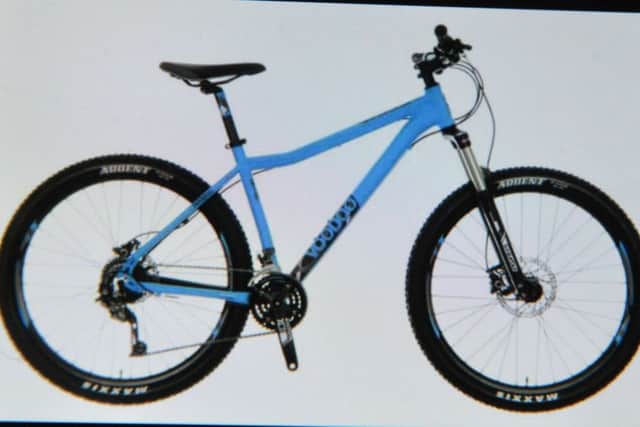 The bike is a blue Voodoo Hoodoo with a white mud guard.
