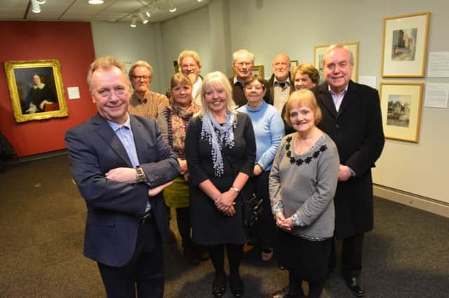 Tutor Malcolm Grady, left, with members of the Workers' Educational Association at the exhibition.