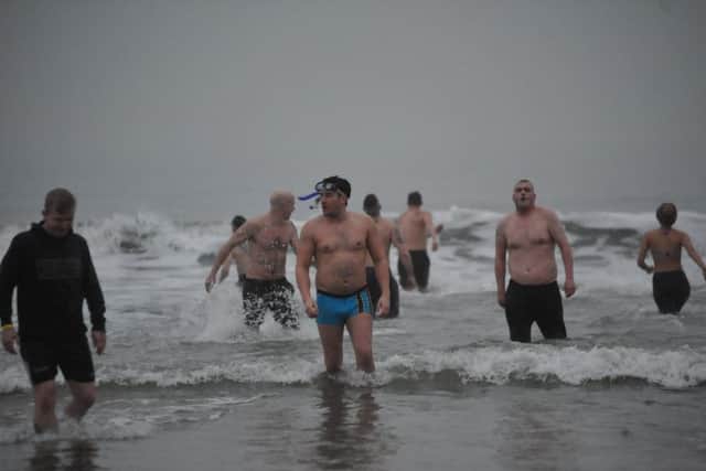 Friends and family of Calvin Mclellan brave the chilly North Sea to raise funds for his family, after he was attacked last year.
