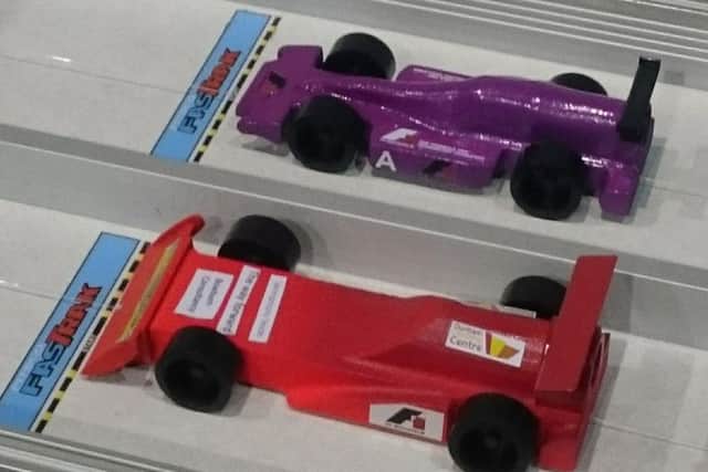 Team Impulso's purple car prepares to take on a rival.