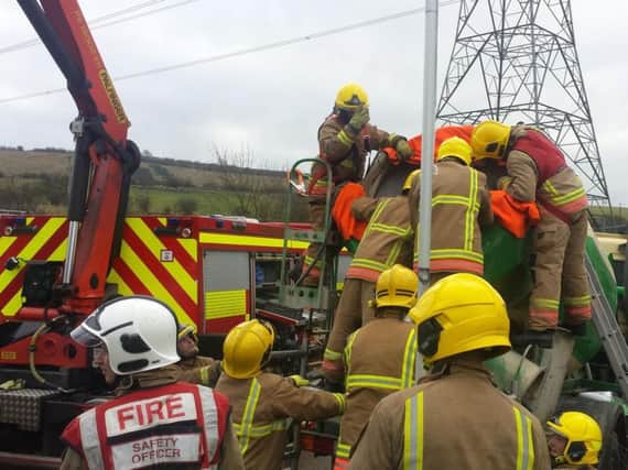 Firefighters battle to rescue the man from inside a cement mixer
