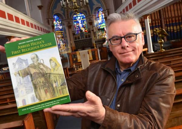 Alan Newham with his book on St Hilda's Church.