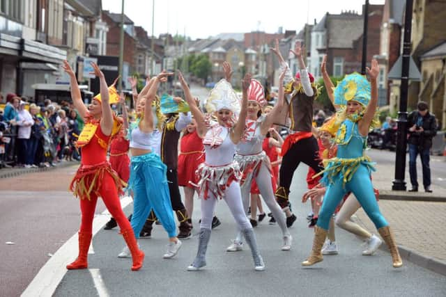 Performers take part in last year's summer parade.