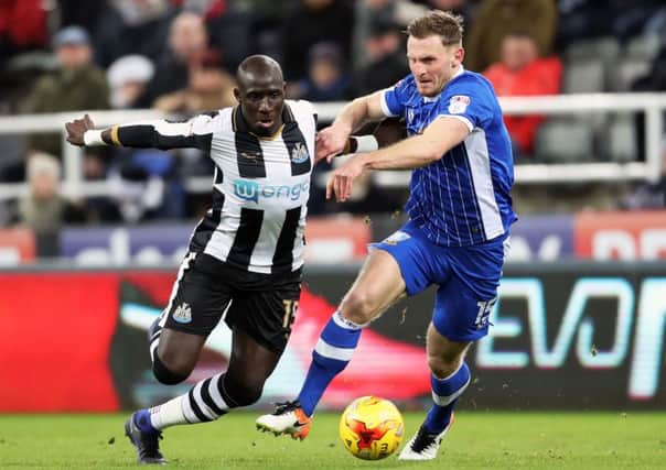 Newcastle Uniteds Mohamed Diame and Sheffield Wednesdays Tom Lees battle for the ball.