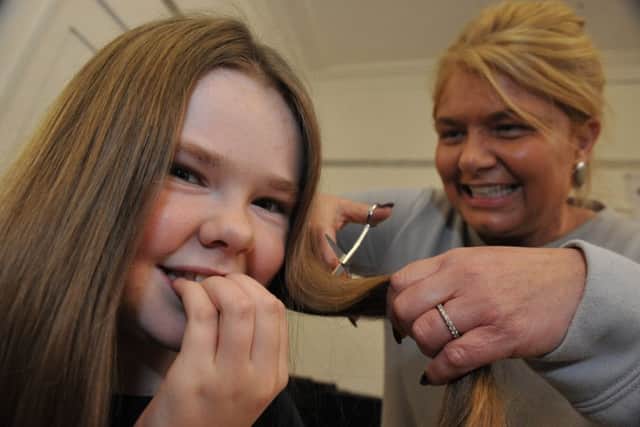 Katie Harte has her hair cut by Creations owner Gillian Maclean, to raise money for the Little Princess Trust.