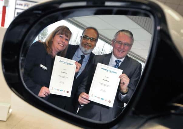 (Centre) Nas Khan, managing director of Jennings Motor Group presents service manager, June Appleyard, and group service and bodyshop manager, Brian Johnston, with their loyalty certificates for a combined 65 years loyalty to the company.