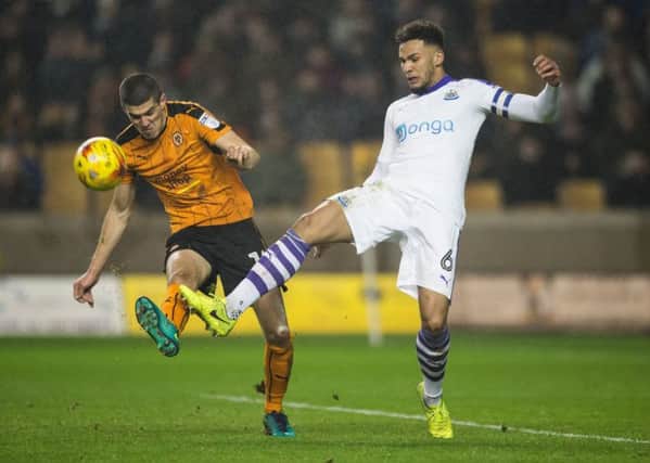 Newcastle Uniteds Jamaal Lascelles challenges Wolverhampton Wanderers Conor Coady.