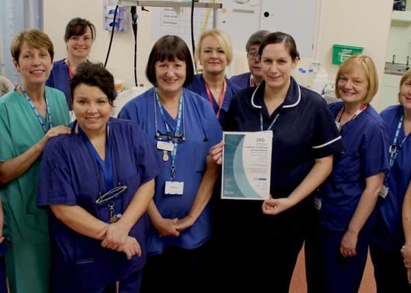 South Tyneside District Hospital Endoscopy unit manager Zoe Clapham, holding the units JAG (Joint Advisory Group on Gastrointestinal Endoscopy) accreditation certificate,  surrounded by other members of the team