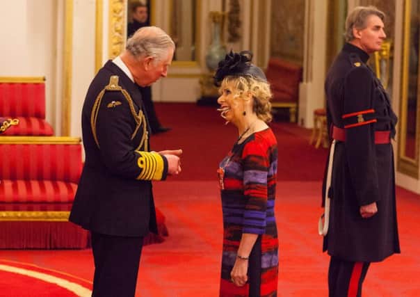 Mrs Margaret Burns  is made an MBE by the Prince of Wales at Buckingham Palace. Photo credit: Dominic Lipinski/PA Archive.