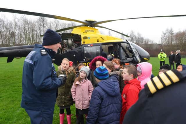 Pupils were able to watch as the police helicopter landed on their school field, before getting the chance to have a look around it and learn about it.
