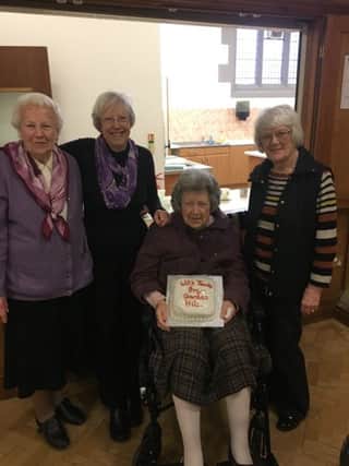 Lilly Burns, 101, centre, delivers a homemade cake to St Michaels Church for their coffee morning.