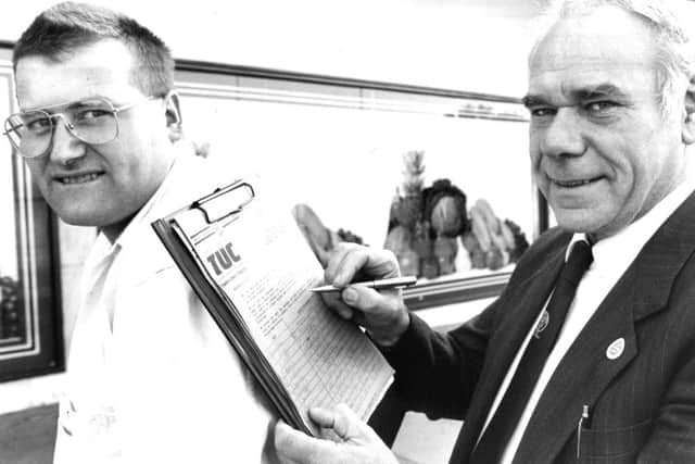 Jarrow MP Don Dixon signs the Northern Region Low Pay Unit petition against low pay on the back of Bob Bolam from the unit in September 1989.