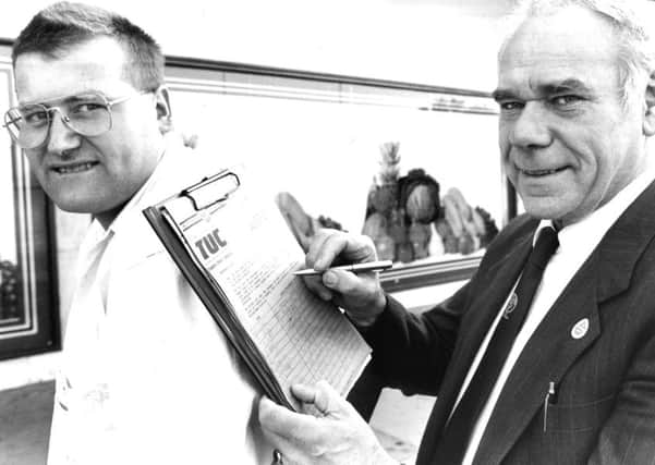 Late Jarrow MP Don Dixon signs the Northern Region Low Pay Unit petition against low pay on the back of Bob Bolam from the unit in September 1989.