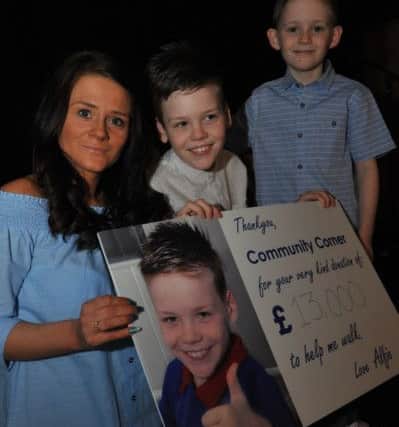 Alfie Smith, with mum Annie and brother Alex are surprised by friends at the Staincliffe Hotel, to help celebrate his fund reaching it's Â£50k target and to announce the date for his operation.