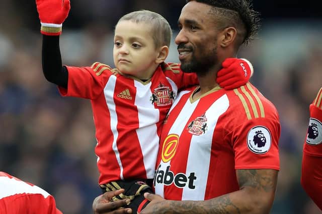 Bradley in the arms of Sunderland's Jermain Defoe before today's game.