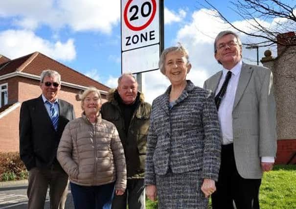 Councillors Moira Smith and Neil Maxwell, with residents Tony Capeling and Patricia Tate, and scheme manager Derek Malcolm, with the new 20mph speed sign.