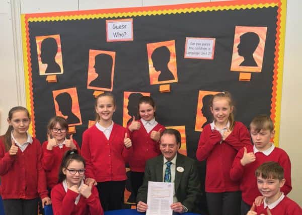 Councillor Alan Smith, chairman of the governing body at Hedworthfield Primary School celebrates with pupils after it was rated as good by Ofsted.