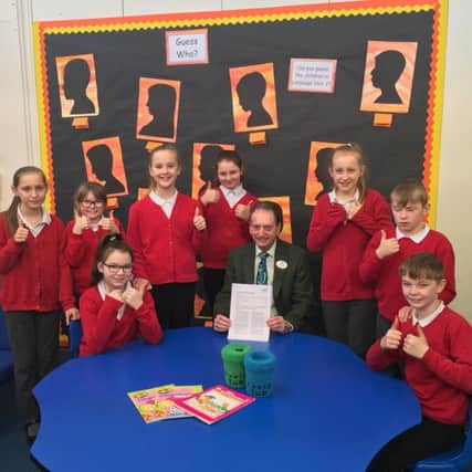Councillor Alan Smith, chairman of the governing body at Hedworthfield Primary School celebrates with pupils after it was rated as good by Ofsted.