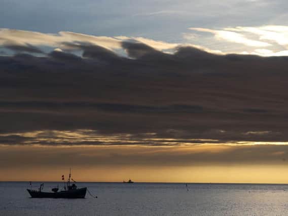 A fishing boat under storm clouds out on the North Sea off the north east coast, as today could be one of the warmest days of the year so far with spring just over a week away. Picture from the Press Association, taken this morning.