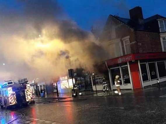 Smoke billows from The Red Hut chip shop at the height of the blaze. Pic: Shyna Noor.