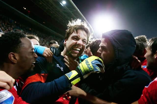 Tim Krul is mobbed after saving a penalty against Cambuur