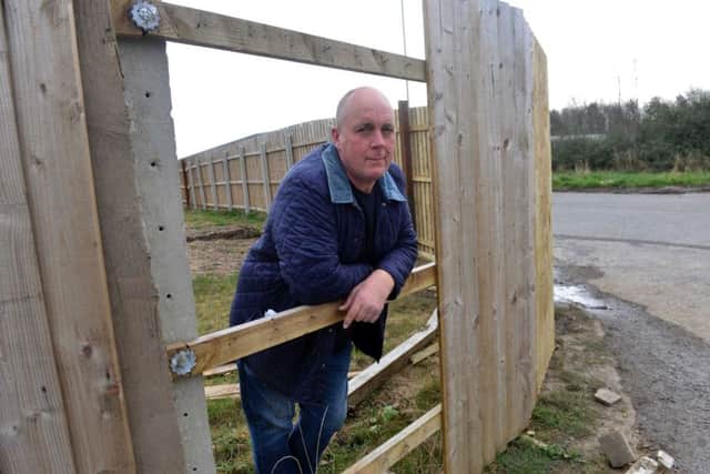 Gary Crutwell at the damaged fence.
