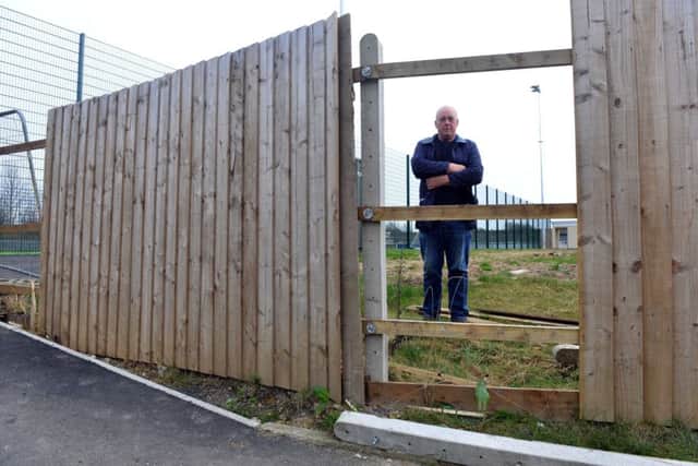 Gary Crutwell at the damaged fence.
