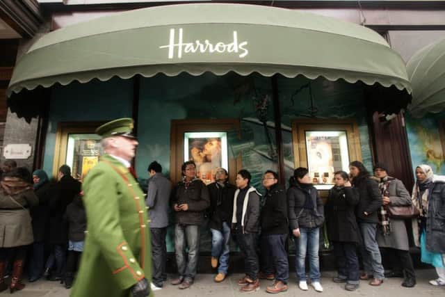 Shoppers queue outside Harrods during the opening of it's winter sale, at Knightsbridge in west London. PRESS ASSOCIATION Photo. Picture date: Monday December 27, 2010. See PA story ECONOMY Sale. Photo credit should read: Yui Mok/PA Wire