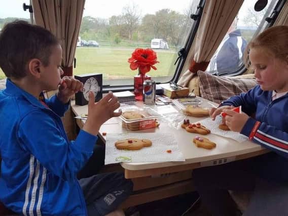Bradley and friend Millie decorate gingerbread at the caravan.