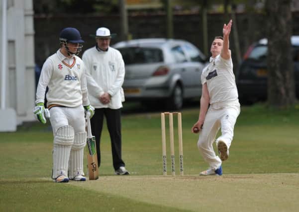 Durham Academy face an onslaught from Whitburn bowler Kieran Waterson.
